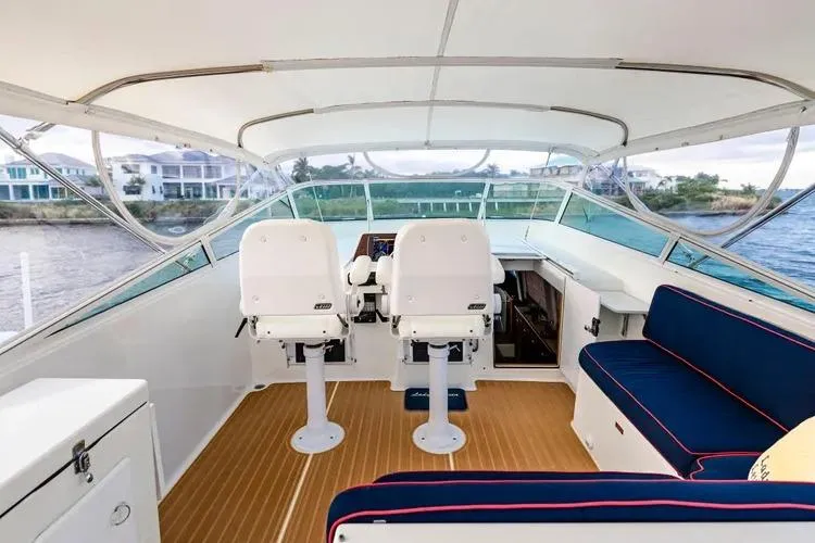  Yacht Photos Pics 2000 Pacific Mariner 65 Motoryacht helm with seating, overlooking waterfront homes.