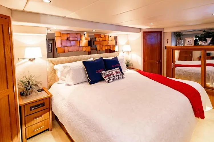  Yacht Photos Pics Luxurious bedroom interior of 2000 Pacific Mariner 65 Motoryacht with elegant decor and cozy bedding.