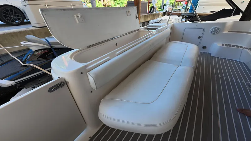 Livin' The Dream Yacht Photos Pics 2001 Sea Ray 450 Express Bridge interior with white seating and storage compartment.