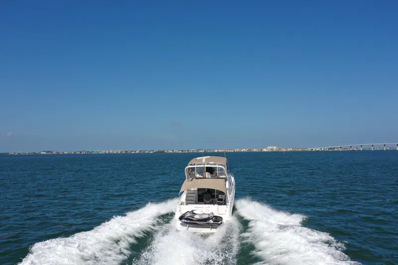 Livin' The Dream Yacht Photos Pics 2001 Sea Ray 450 Express Bridge cruising on open water under clear blue sky.