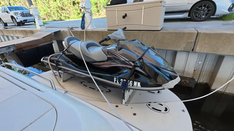 Livin' The Dream Yacht Photos Pics Jet ski secured on a 2001 Sea Ray 450 Express Bridge at a dock.