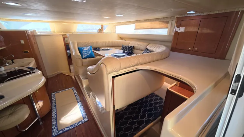 Livin' The Dream Yacht Photos Pics Luxurious interior of 2001 Sea Ray 450 Express Bridge yacht with elegant seating and cabinetry.