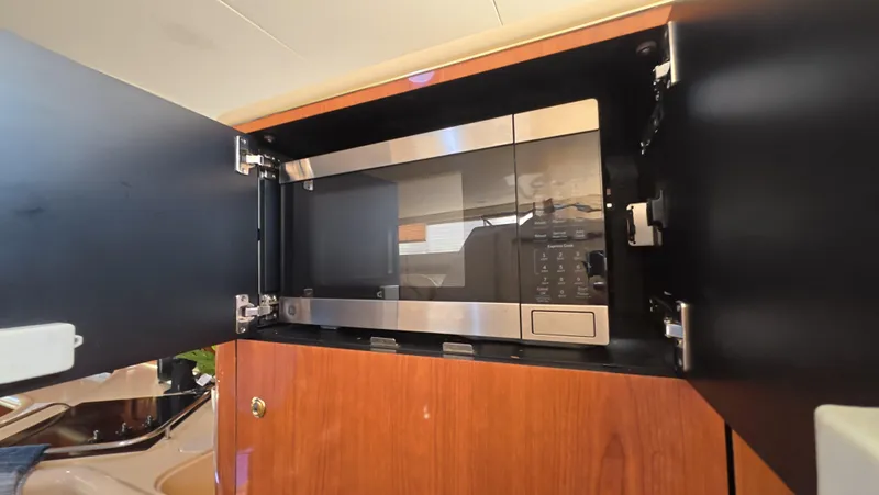 Livin' The Dream Yacht Photos Pics Microwave in 2001 Sea Ray 450 Express Bridge yacht kitchen cabinet.