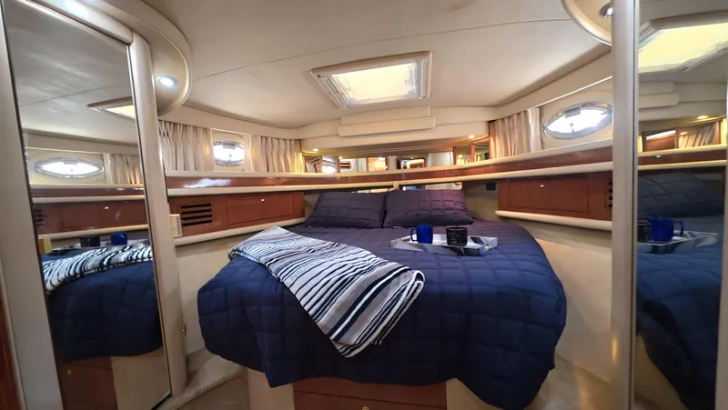 Livin' The Dream Yacht Photos Pics Luxurious cabin interior of 2001 Sea Ray 450 Express Bridge yacht with cozy bedding.