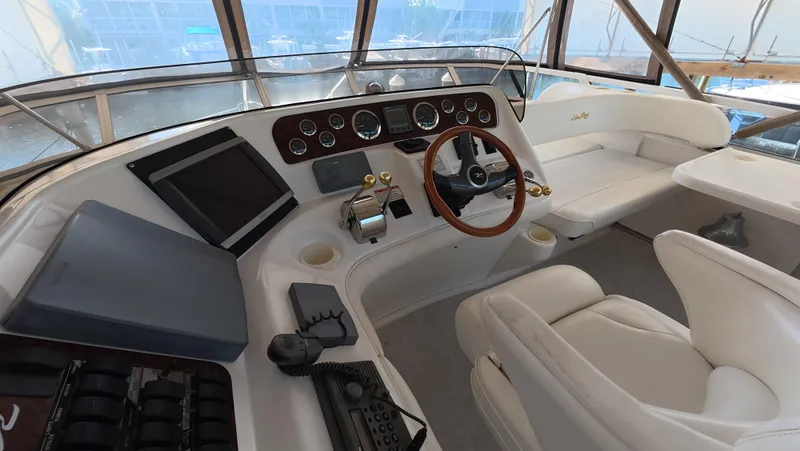 Livin' The Dream Yacht Photos Pics 2001 Sea Ray 450 Express Bridge helm with modern controls and luxurious seating.