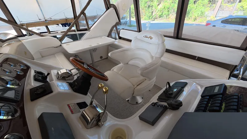 Livin' The Dream Yacht Photos Pics 2001 Sea Ray 450 Express Bridge helm with luxurious seating and control panel.