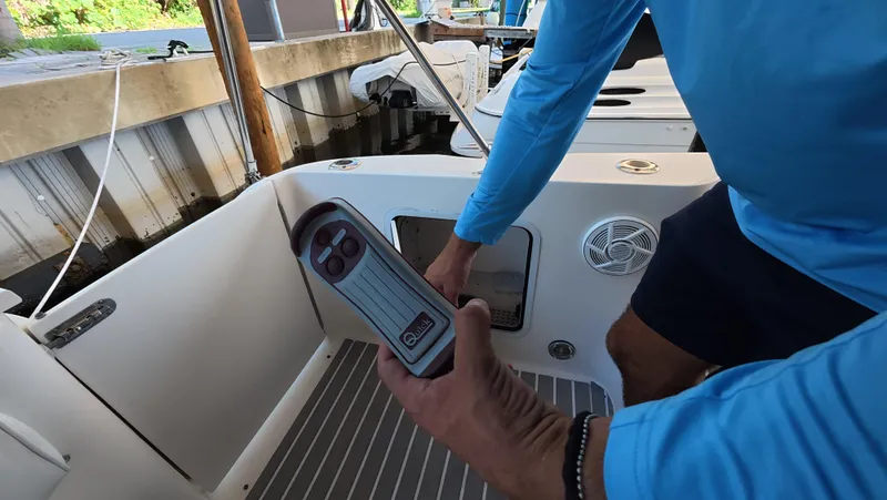 Livin' The Dream Yacht Photos Pics Man operating controls on a 2001 Sea Ray 450 Express Bridge boat.