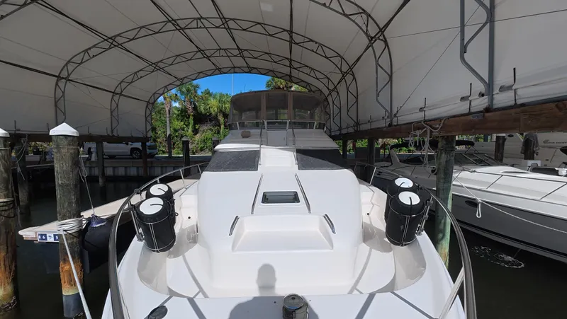 Livin' The Dream Yacht Photos Pics 2001 Sea Ray 450 Express Bridge yacht docked under a canopy.