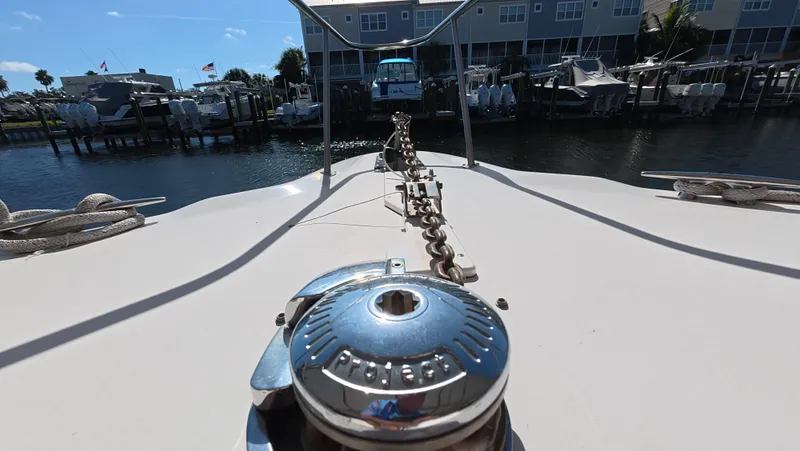 Livin' The Dream Yacht Photos Pics Bow view of 2001 Sea Ray 450 Express Bridge at marina, showcasing anchor chain and winch.