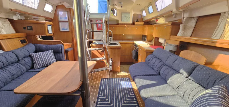  Yacht Photos Pics Luxurious interior of a 2005 Hunter 456 yacht with cozy seating and wooden finishes.
