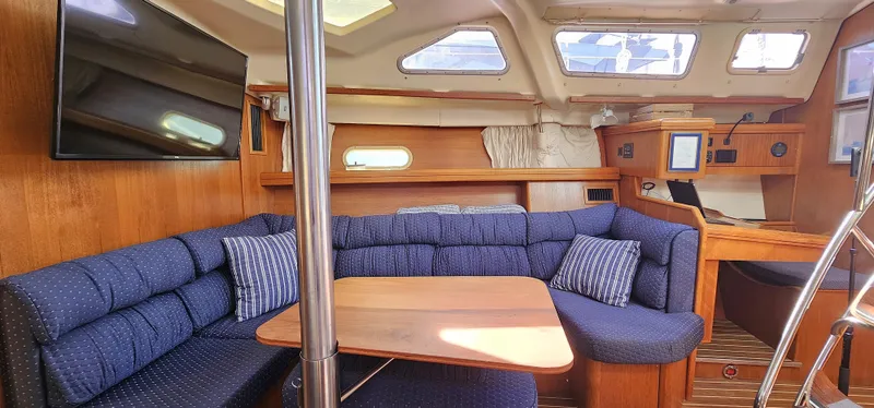  Yacht Photos Pics Interior of 2005 Hunter 456 yacht with cozy seating and wooden table.