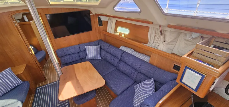  Yacht Photos Pics Interior of 2005 Hunter 456 yacht with blue seating and wooden accents.