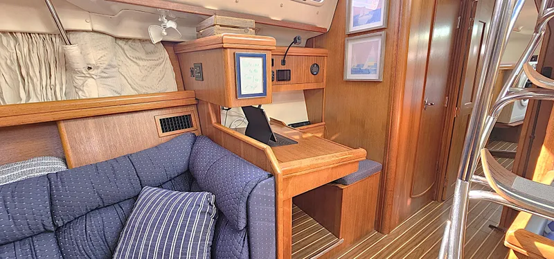  Yacht Photos Pics Interior of 2005 Hunter 456 yacht with wooden furnishings and blue upholstery.