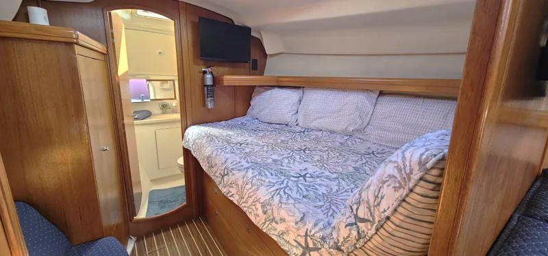  Yacht Photos Pics Cozy cabin interior of 2005 Hunter 456 yacht with bed and wooden furnishings.