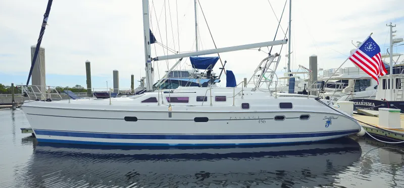  Yacht Photos Pics 2005 Hunter 456 sailboat docked at marina with American flag.
