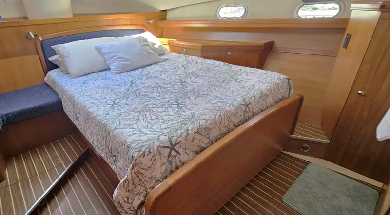  Yacht Photos Pics Luxurious cabin interior of 2005 Hunter 456 yacht with comfortable bed and wooden finish.