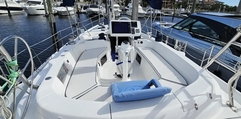  Yacht Photos Pics 2005 Hunter 456 sailboat cockpit with navigation equipment, docked at a marina.