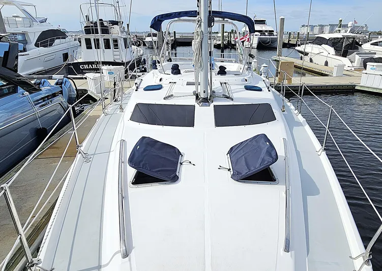  Yacht Photos Pics Sailboat docked at marina, Hunter 456 model, 2005, with open hatches and clear sky.