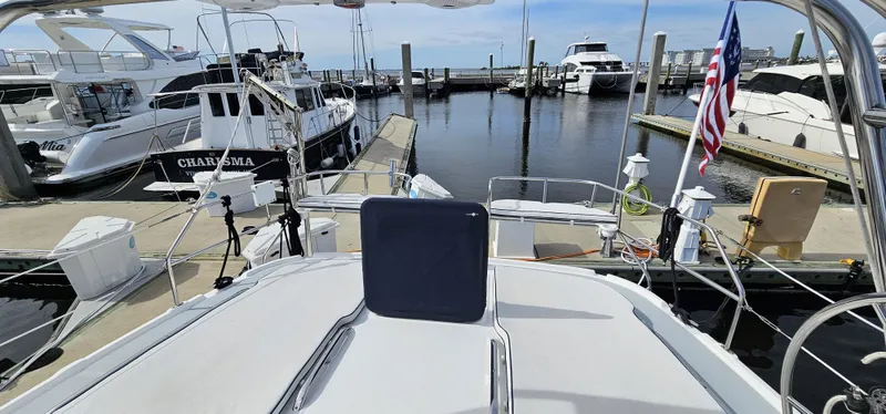  Yacht Photos Pics 2005 Hunter 456 yacht docked at marina, surrounded by other boats, with clear blue sky.