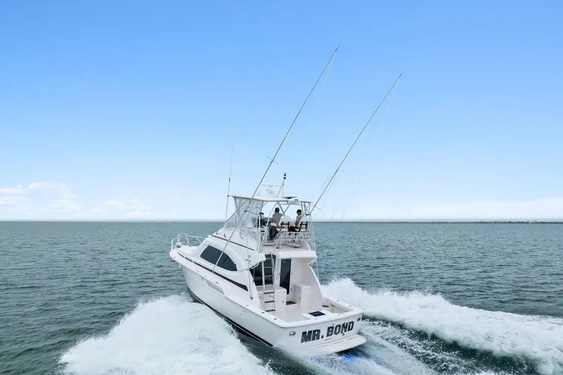 Mr. Bond Yacht Photos Pics 2006 Bertram 39 Convertible yacht cruising on open water.