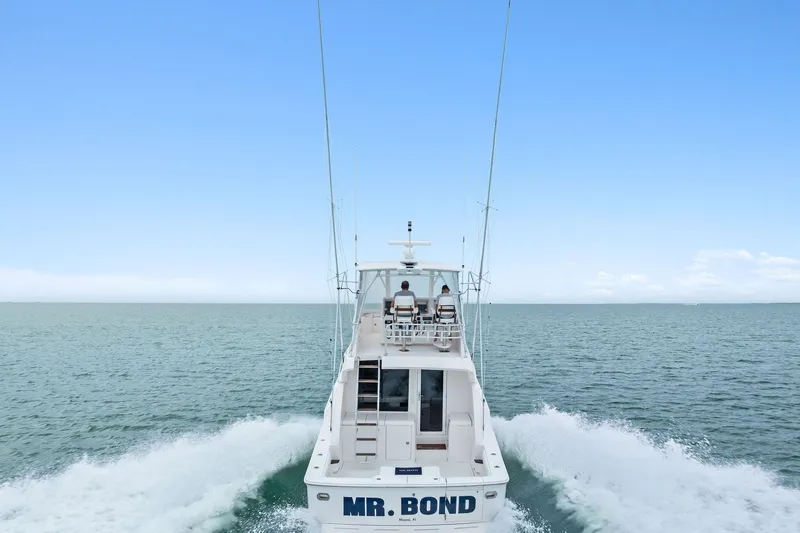 Mr. Bond Yacht Photos Pics 2006 Bertram 39 Convertible yacht cruising on open sea, rear view.