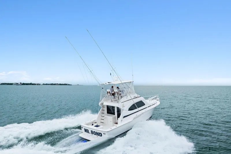Mr. Bond Yacht Photos Pics 2006 Bertram 39 Convertible yacht cruising on open water under clear blue sky.