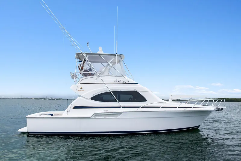 Mr. Bond Yacht Photos Pics 2006 Bertram 39 Convertible yacht on calm water under clear blue sky.