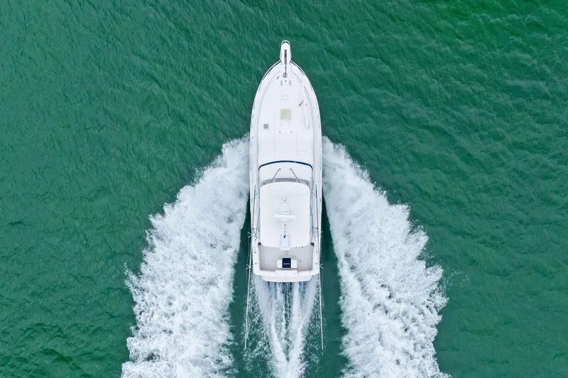 Mr. Bond Yacht Photos Pics Aerial view of 2006 Bertram 39 Convertible yacht cruising on green water.