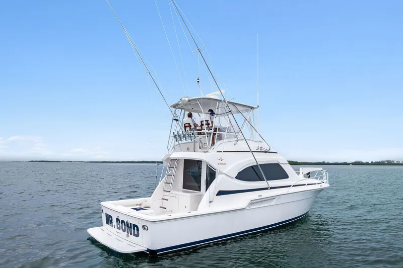 Mr. Bond Yacht Photos Pics 2006 Bertram 39 Convertible yacht on open water under clear blue sky.