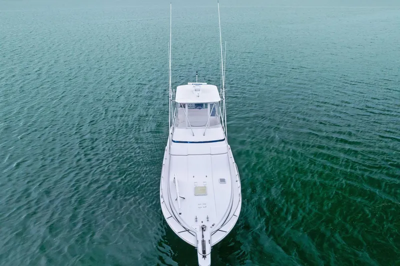 Mr. Bond Yacht Photos Pics 2006 Bertram 39 Convertible yacht on calm ocean waters, aerial view.