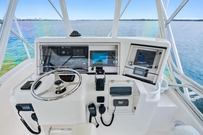 Mr. Bond Yacht Photos Pics 2006 Bertram 39 Convertible helm with navigation equipment and ocean view.