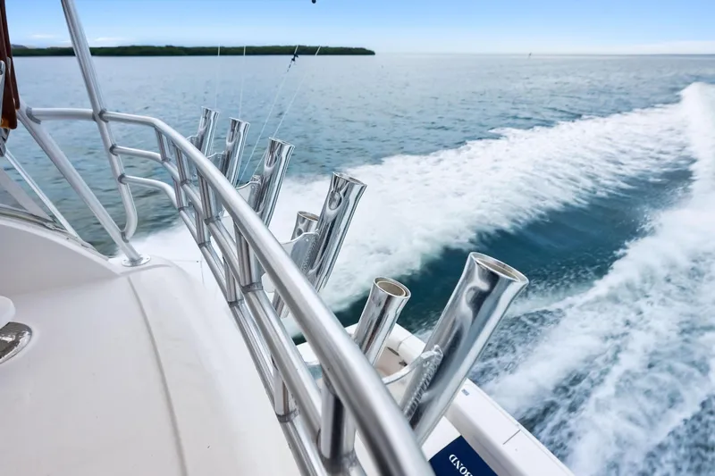 Mr. Bond Yacht Photos Pics 2006 Bertram 39 Convertible yacht cruising on open water, featuring sleek metal railings.