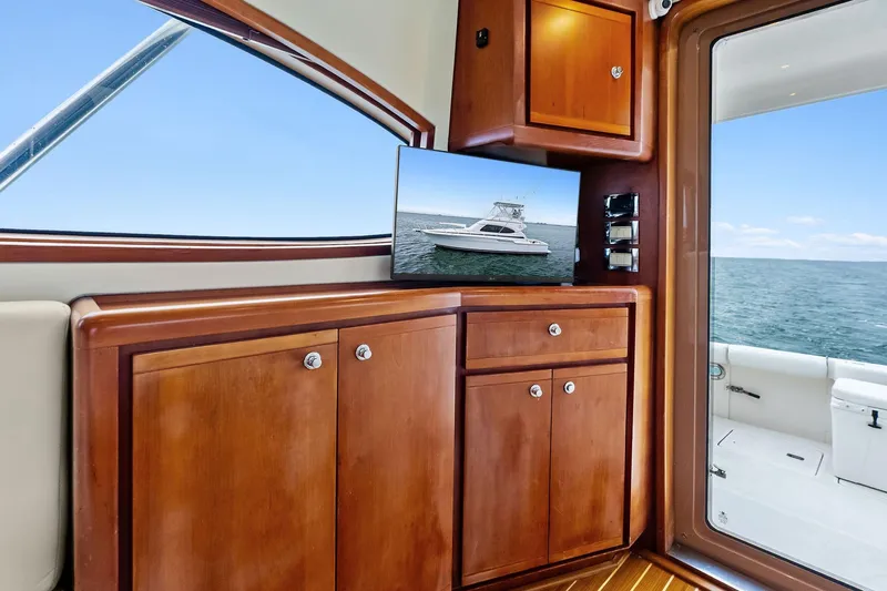Mr. Bond Yacht Photos Pics Interior of 2006 Bertram 39 Convertible yacht with wooden cabinetry and ocean view.