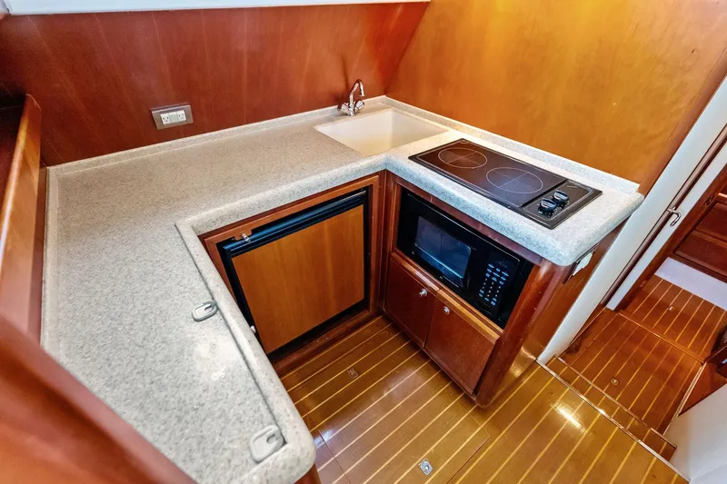 Mr. Bond Yacht Photos Pics 2006 Bertram 39 Convertible yacht kitchen with stove, microwave, and sink.