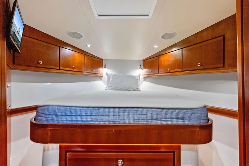 Mr. Bond Yacht Photos Pics Luxurious cabin interior of 2006 Bertram 39 Convertible yacht with wooden cabinetry.