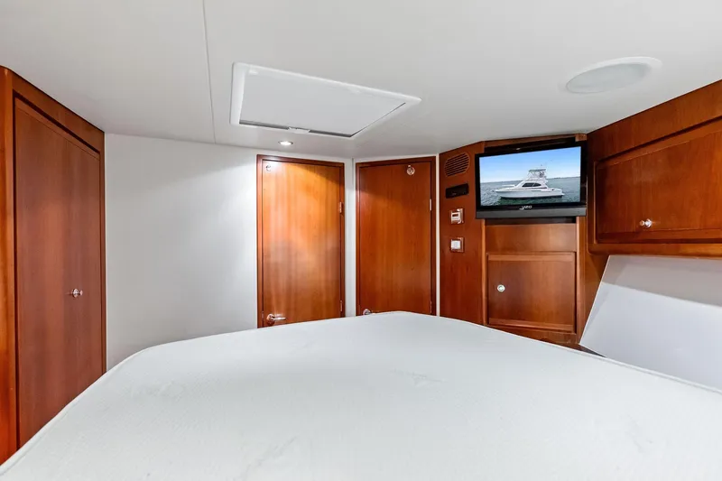 Mr. Bond Yacht Photos Pics Interior of 2006 Bertram 39 Convertible yacht with wood cabinetry and mounted TV.