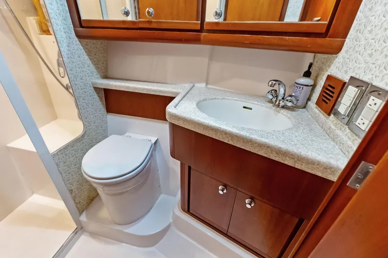 Mr. Bond Yacht Photos Pics 2006 Bertram 39 Convertible yacht bathroom with sink, toilet, and shower.