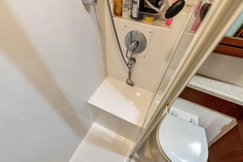 Mr. Bond Yacht Photos Pics Bathroom interior of 2006 Bertram 39 Convertible yacht, featuring shower and toilet.