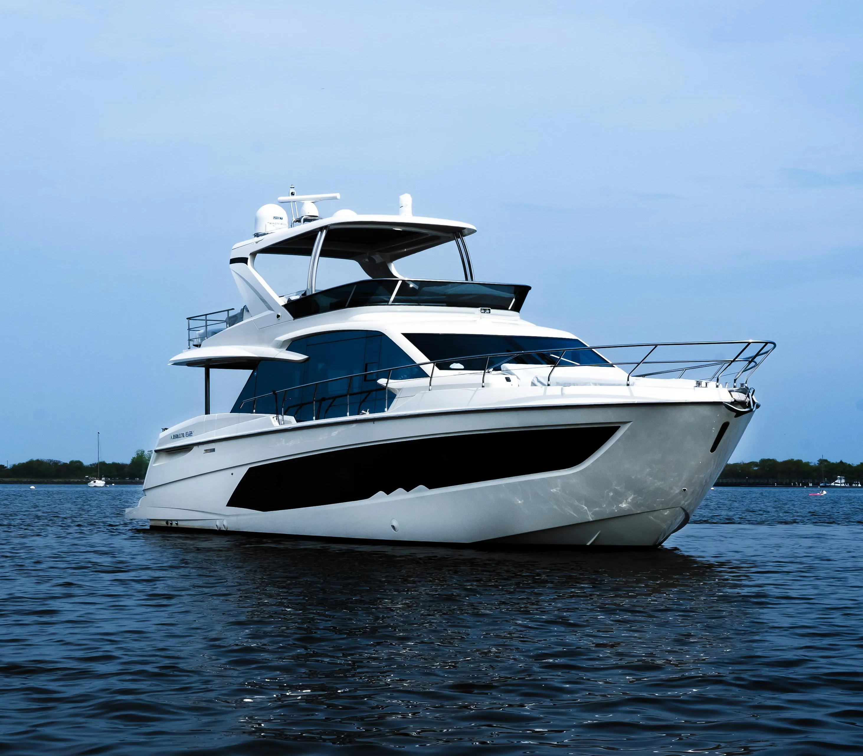 Luxury Absolute 62 Fly yacht, 2022 model, cruising on calm waters under a clear sky.