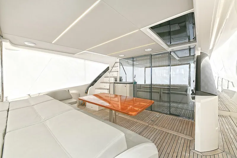  Yacht Photos Pics Luxurious interior of 2022 Absolute 62 Fly yacht with modern seating and wooden table.