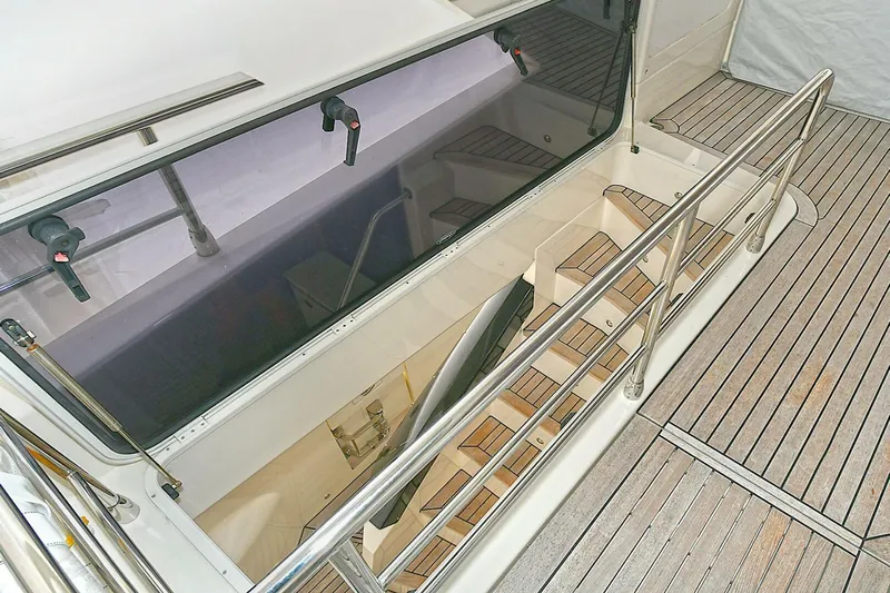  Yacht Photos Pics Staircase on 2022 Absolute 62 Fly yacht with wooden deck and railing.
