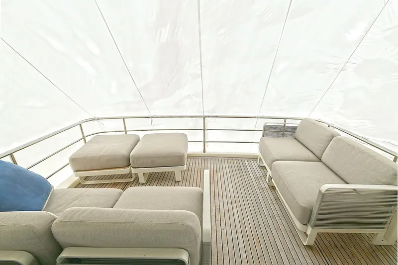  Yacht Photos Pics Luxurious seating area on 2022 Absolute 62 Fly yacht with modern design and wooden deck.