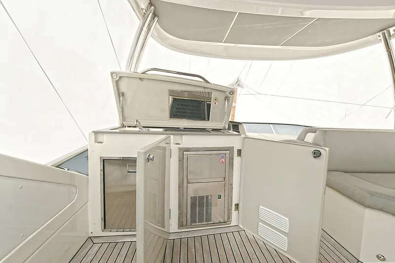  Yacht Photos Pics Luxury yacht Absolute 62 Fly 2022 interior with open storage compartments and sleek design.