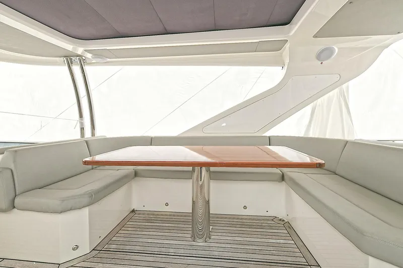  Yacht Photos Pics Luxurious seating area on a 2022 Absolute 62 Fly yacht with elegant wood table.