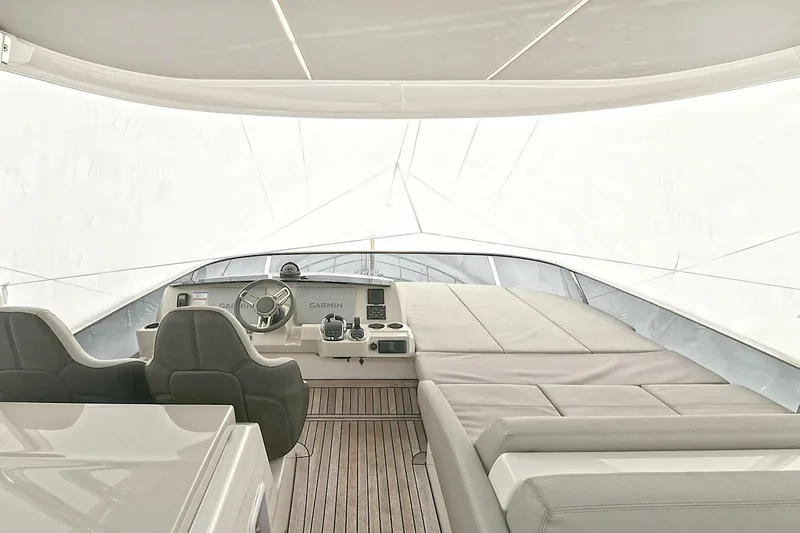  Yacht Photos Pics Luxurious interior of 2022 Absolute 62 Fly yacht with modern helm and seating.