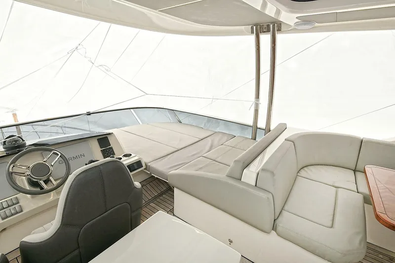  Yacht Photos Pics Luxurious interior of 2022 Absolute 62 Fly yacht with modern seating and steering area.