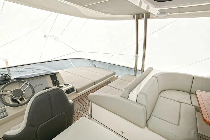  Yacht Photos Pics Luxurious interior of 2022 Absolute 62 Fly yacht with modern seating and helm.