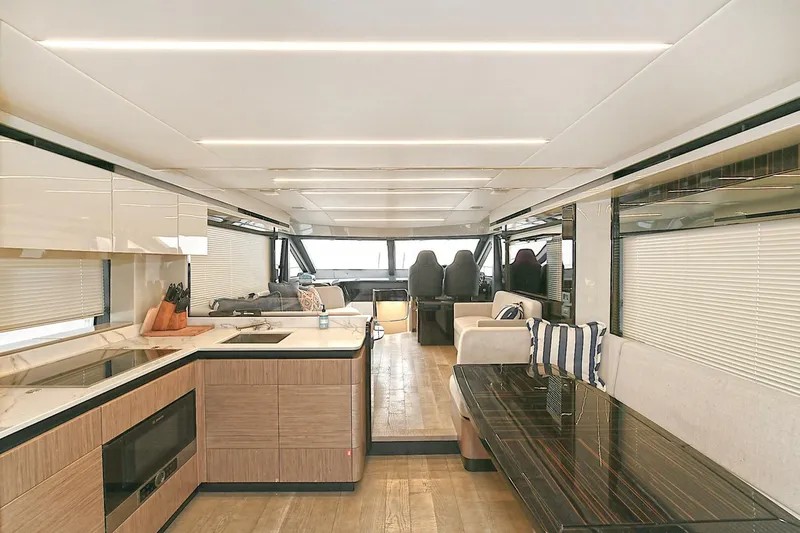  Yacht Photos Pics Luxurious interior of 2022 Absolute 62 Fly yacht with modern kitchen and seating area.