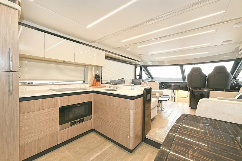  Yacht Photos Pics Luxurious interior of 2022 Absolute 62 Fly yacht with modern kitchen and seating area.