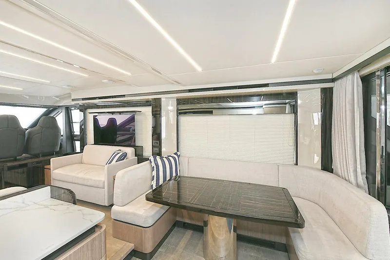  Yacht Photos Pics Luxurious interior of 2022 Absolute 62 Fly yacht with modern seating and dining area.